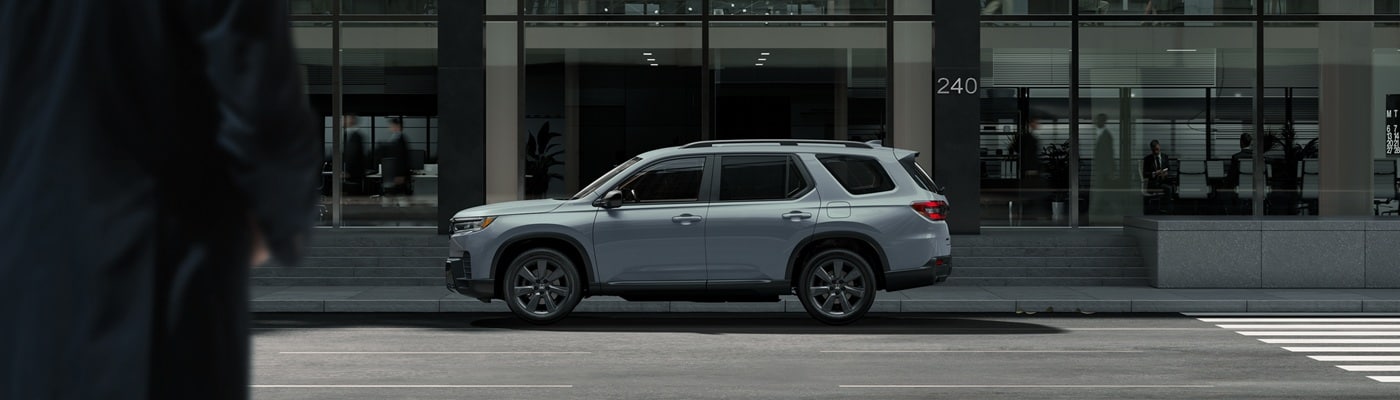 Grey Honda Pilot Elite parked in a city
