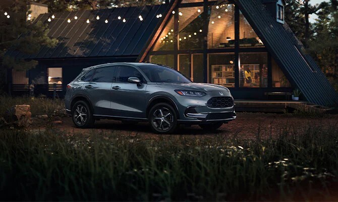 Honda HR-V Light Blue Honda HR-V parked by a modern log cabin
