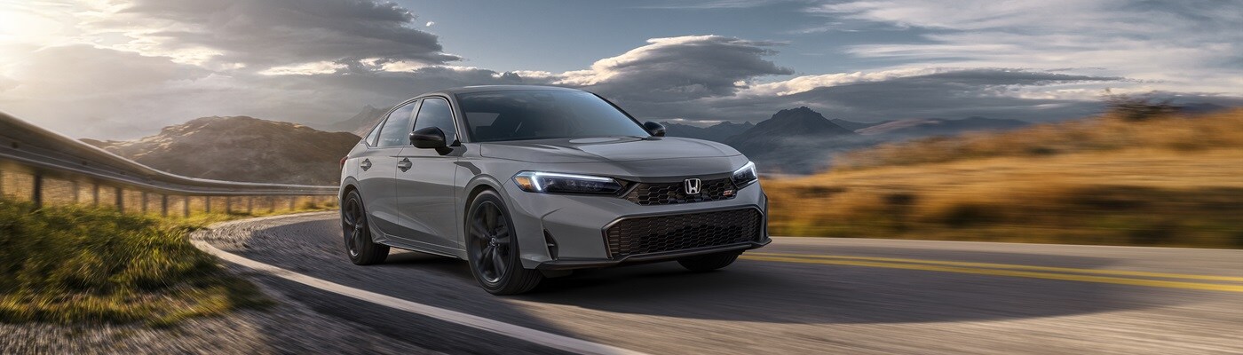 Honda Civic Si Grey Honda Civic Si driving on a road near dusk