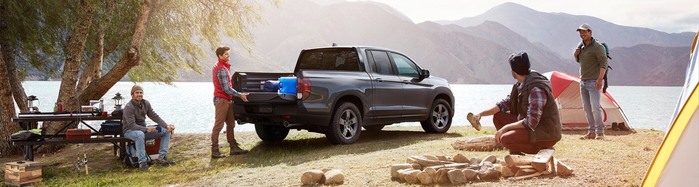 Honda Ridgeline Grey Honda Ridgeline TrailSport parked at a campsite by the lake