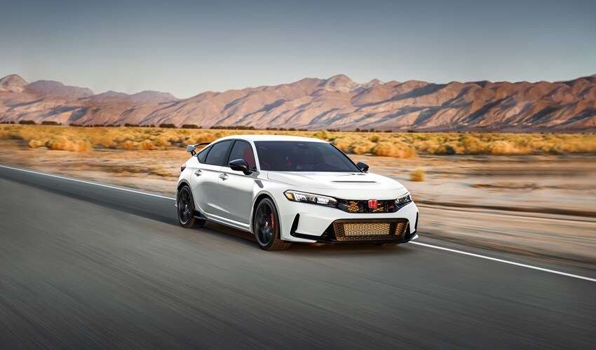 Honda Civic Type R White Honda Civic Type R driving on a desert road