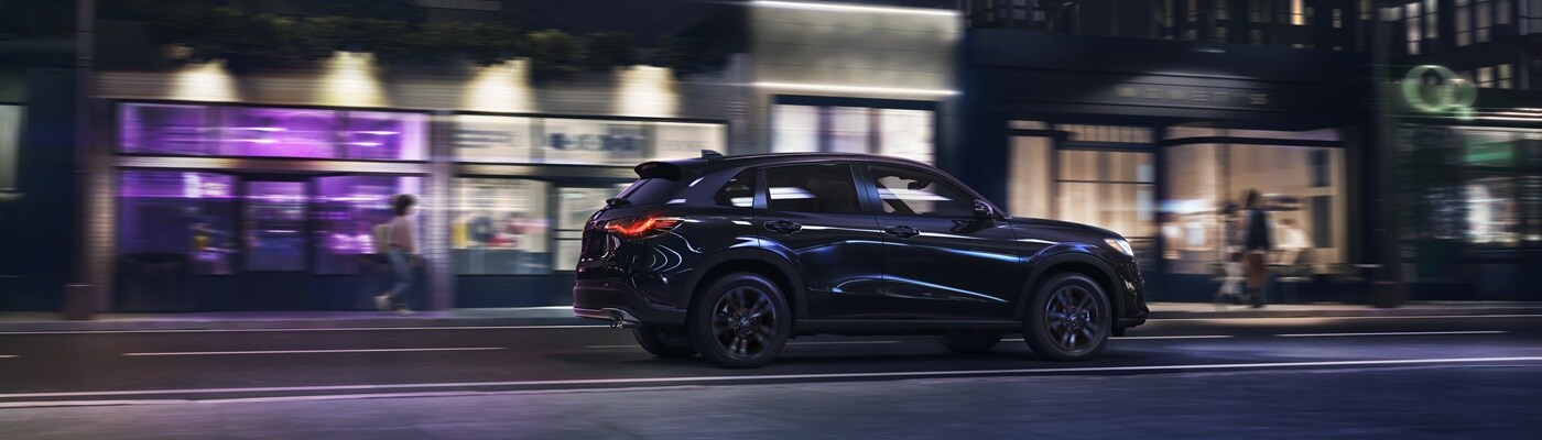Honda HR-V Black HR-V Sport driving on a city street at night