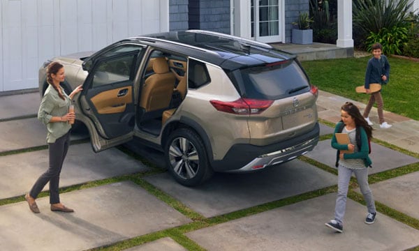 Mom Opening the Car Door of Her Nissan SUV for Her Kids