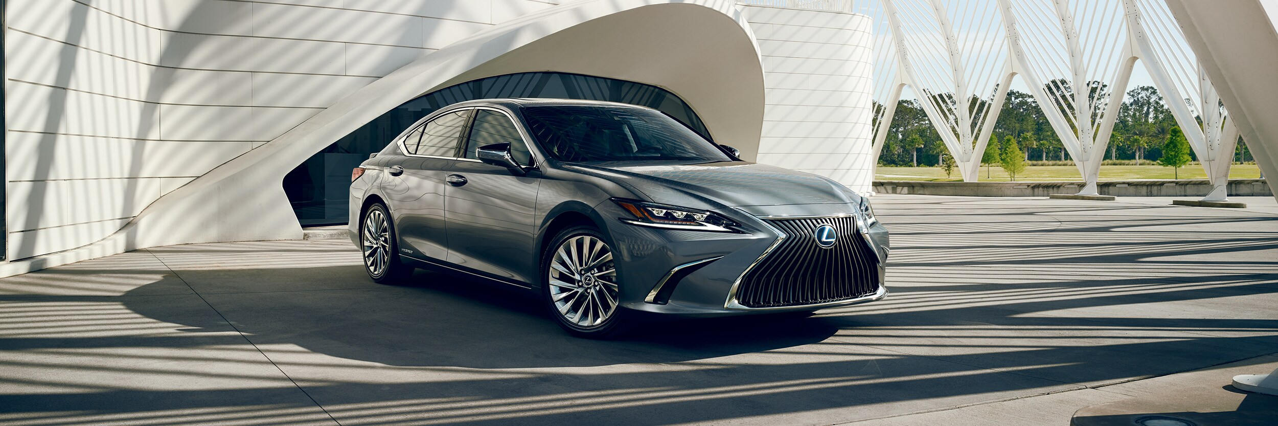 Lexus ES sedan parked by a modern house