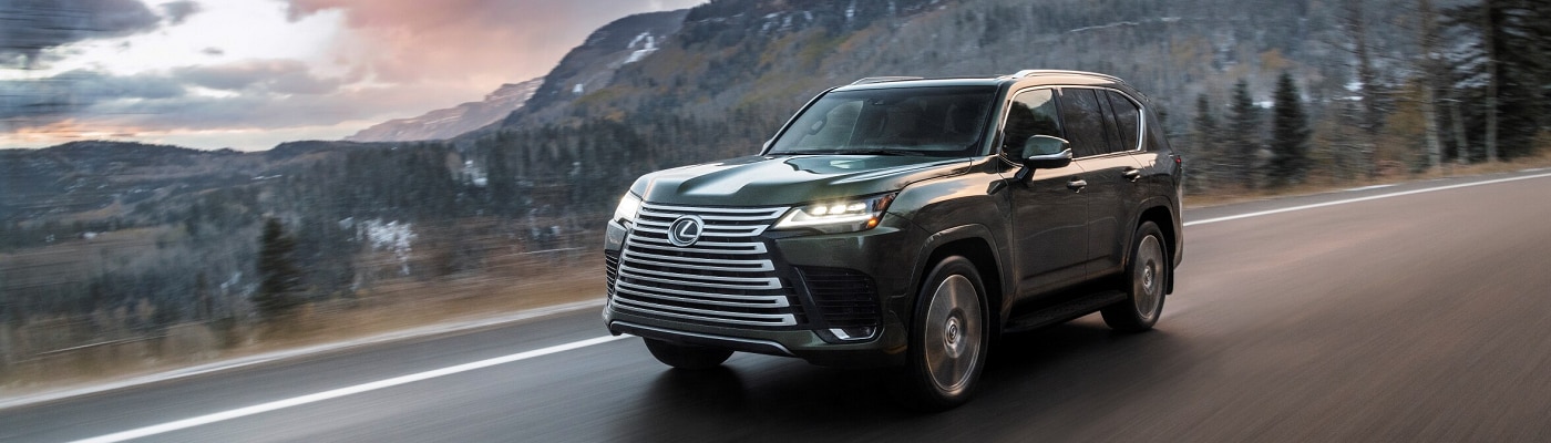 Green 2023 Lexus LX 600 driving in the mountains