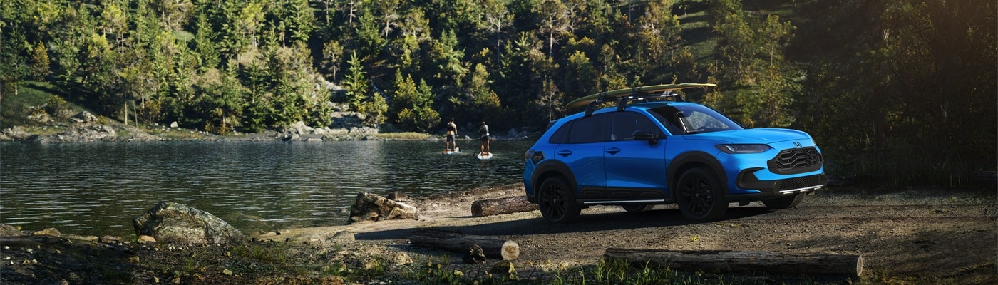 Blue HR-V parked at the side of a lake