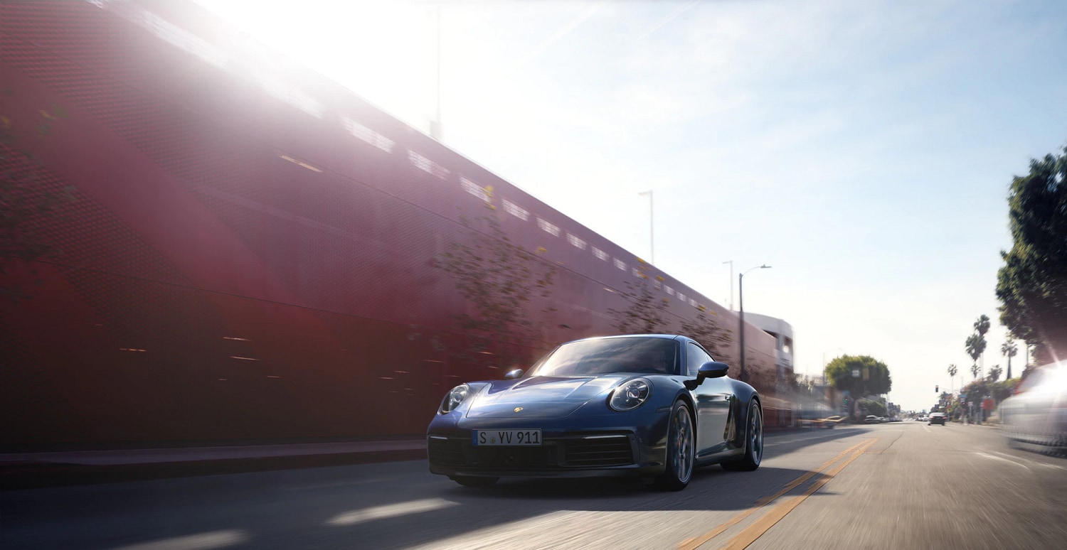 Porsche 911 Carrera 4S driving on a city street