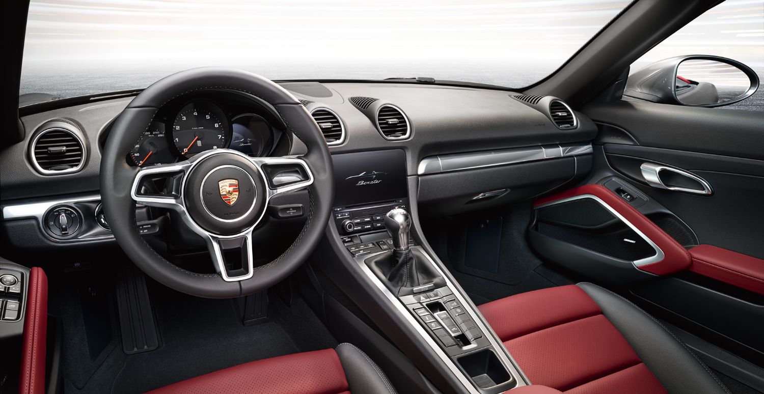 interior view of a Porsche 718 Boxster with red and black leather