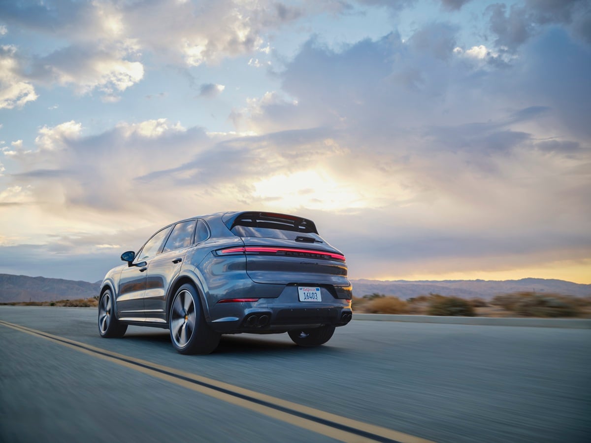 Porsche Cayenne S driving on a road in a desert