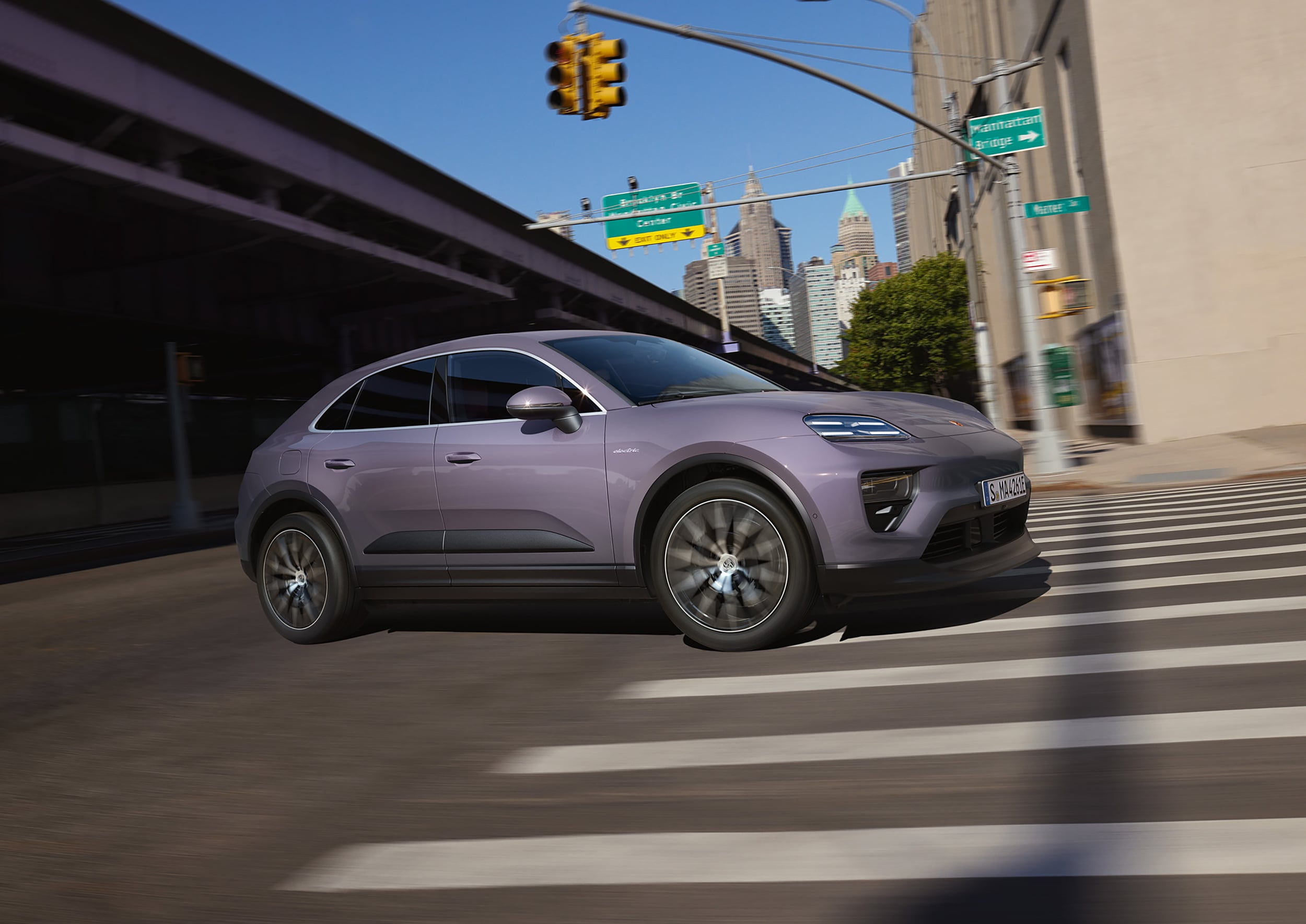 Porsche Macan 4 Electric Lavender Porsche Macan 4 Electric driving in a city