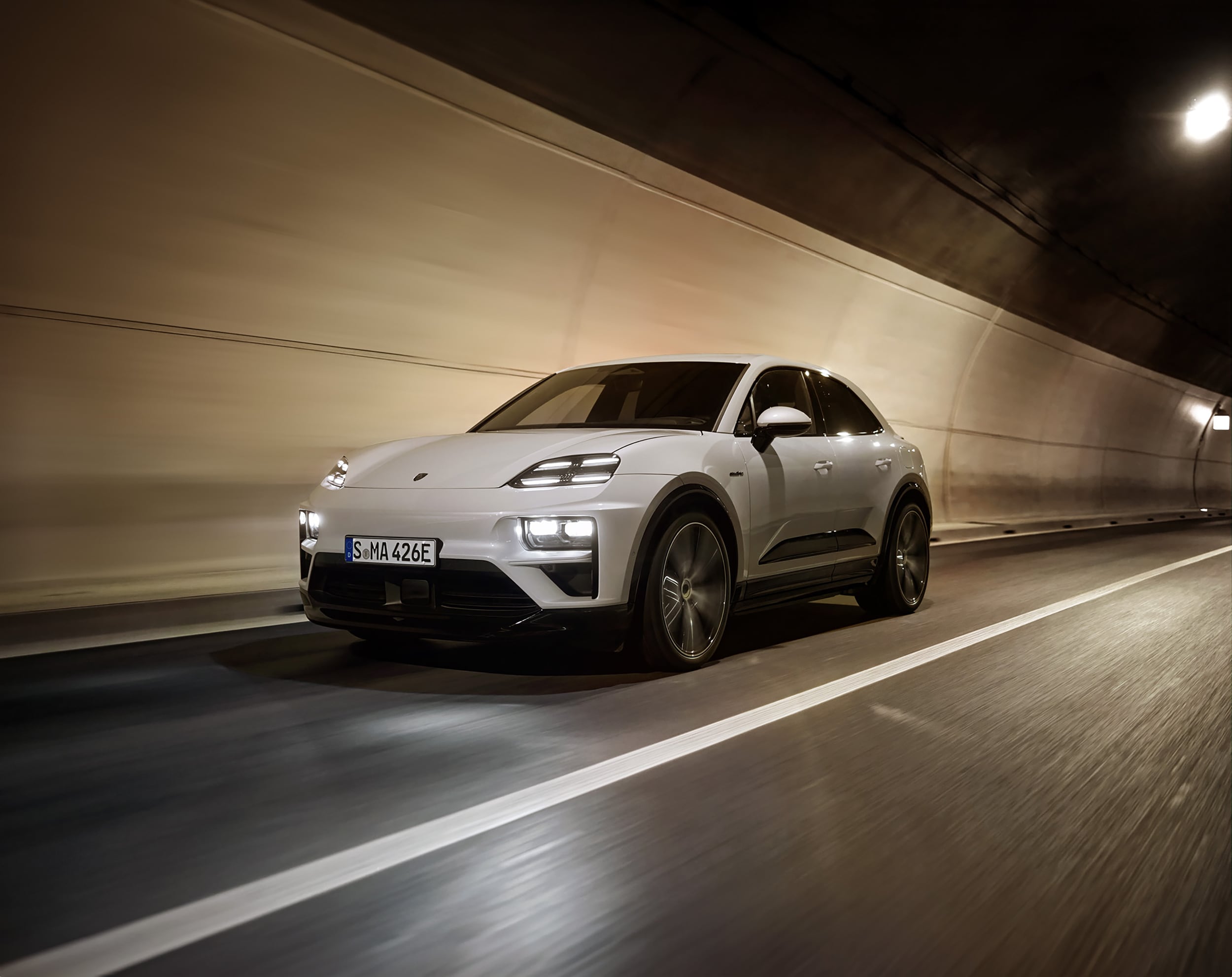 Porsche Macan Turbo Electric White Macan Turbo Electric driving in a tunnel