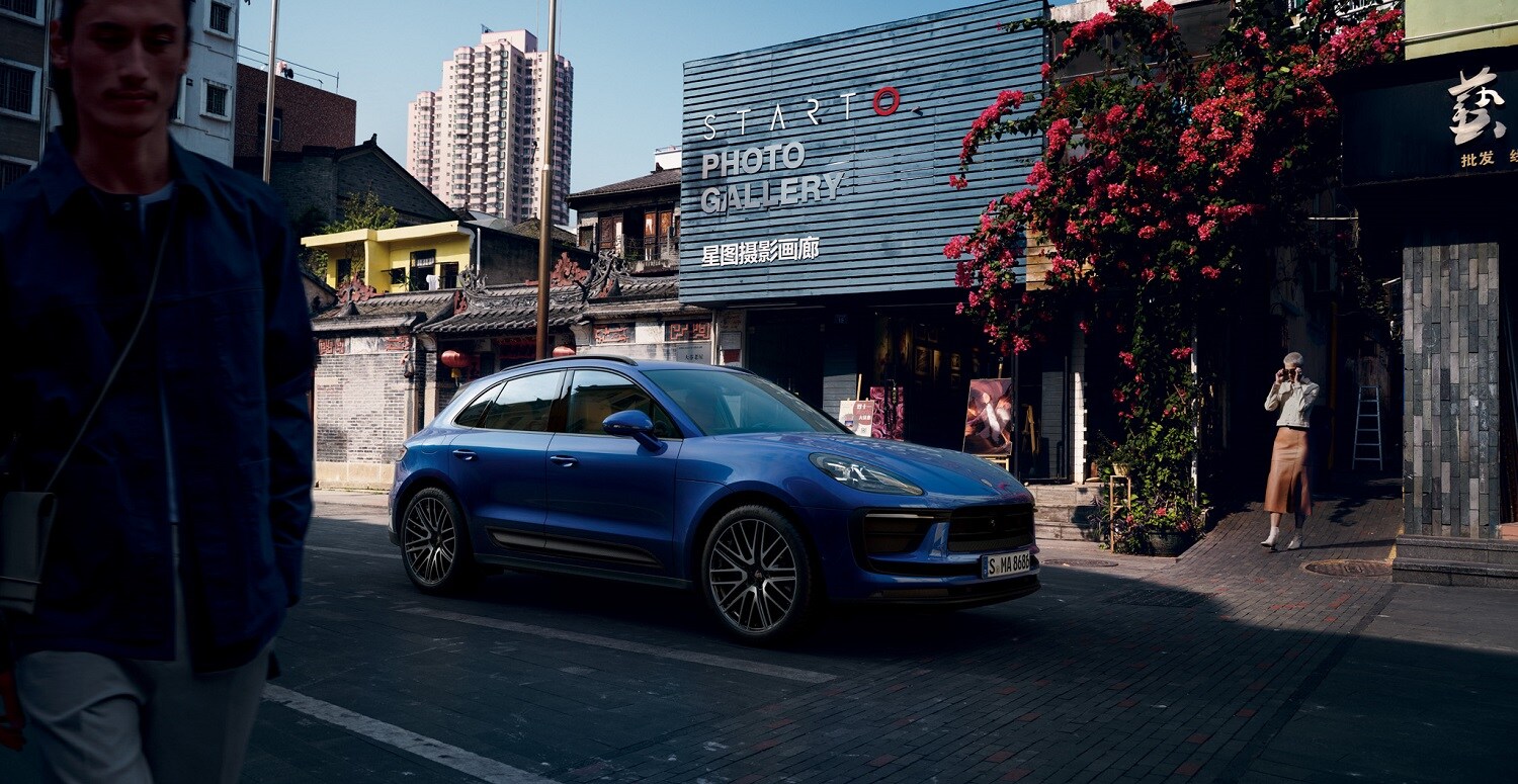 Porsche Macan Porsche Macan parked by a photo gallery