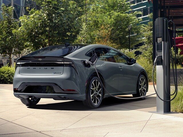 Toyota Prius PHEV XSE charging in a city