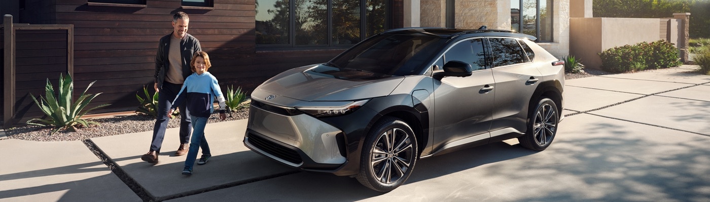 Grey Toyota bZ4X
parked in front of a modern home