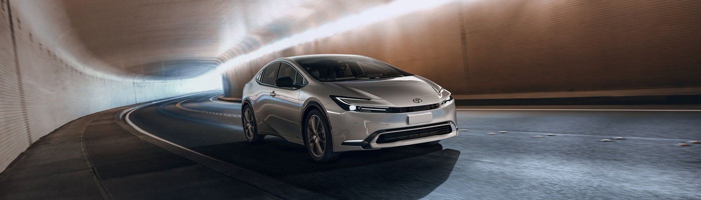 Silver Toyota Prius Limited AWD driving in a city tunnel