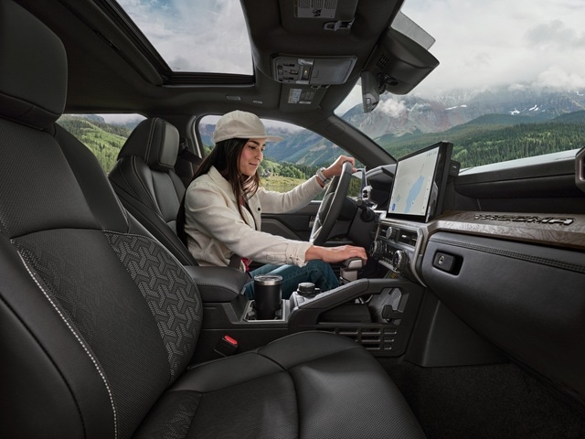 Person sitting in the driver's seat of a Toyota Tacoma