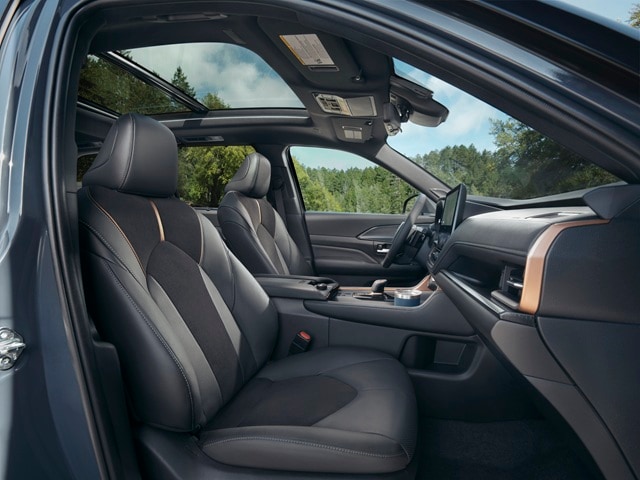 The interior of a Grand Highlander Hybrid parked out
in the woods