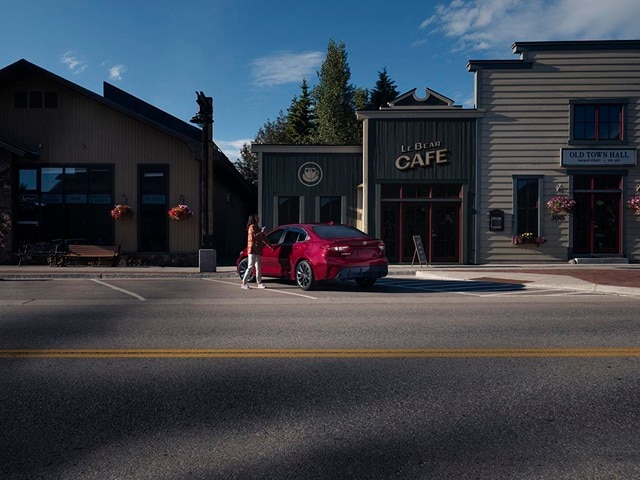 Red Toyota Corolla Hybrid SE parked in a mountain town