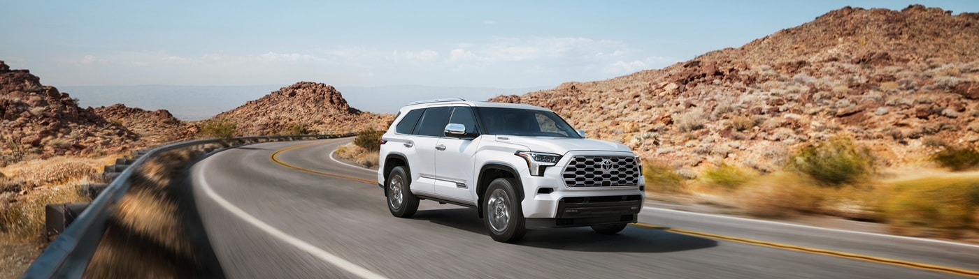 White Toyota Sequoia
1794 Edition driving on a road in the desert
