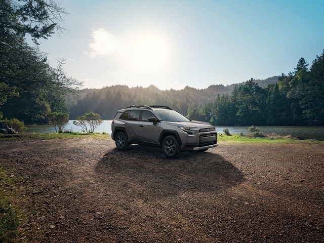 Grey Toyota RAV4 parked beside a lake