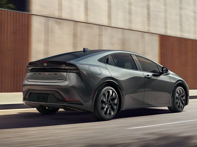 Grey Prius PHEV XSE driving in a city