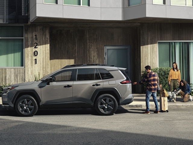 Grey Toyota RAV4 SUV parked in front of an apartment building
