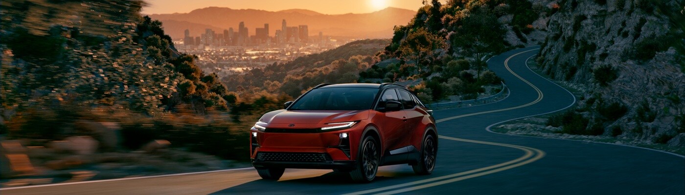 Orange Toyota C-HR EV driving on a road outside of LA