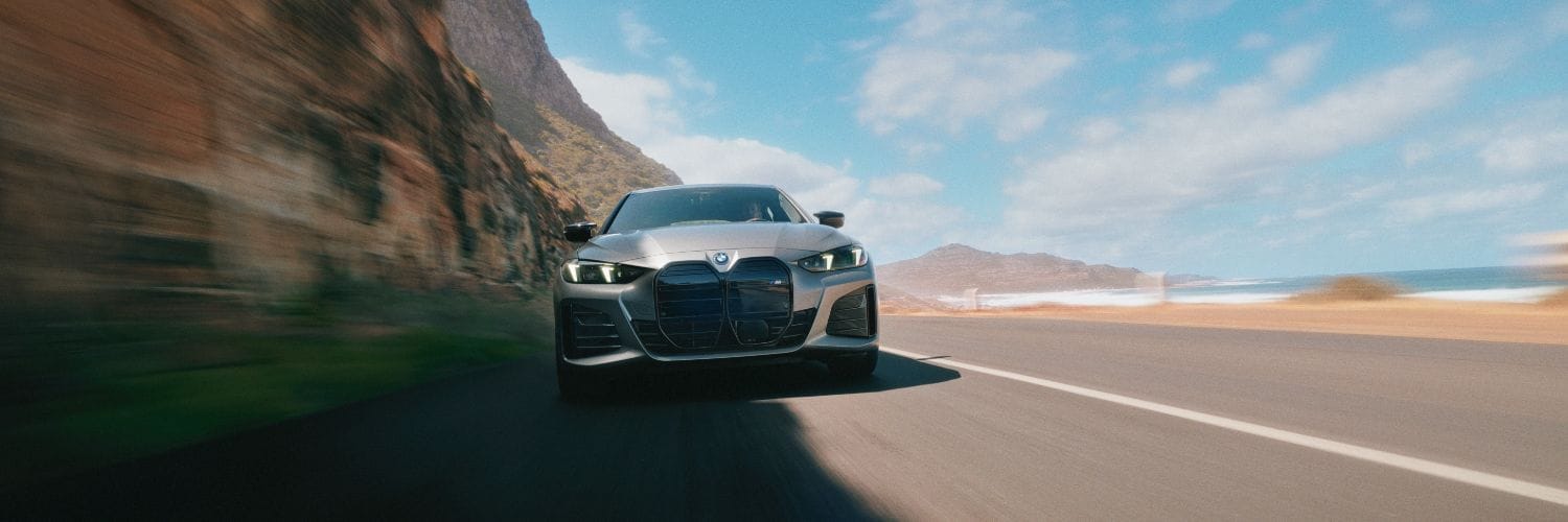 BMW i4 driving up a mountain road