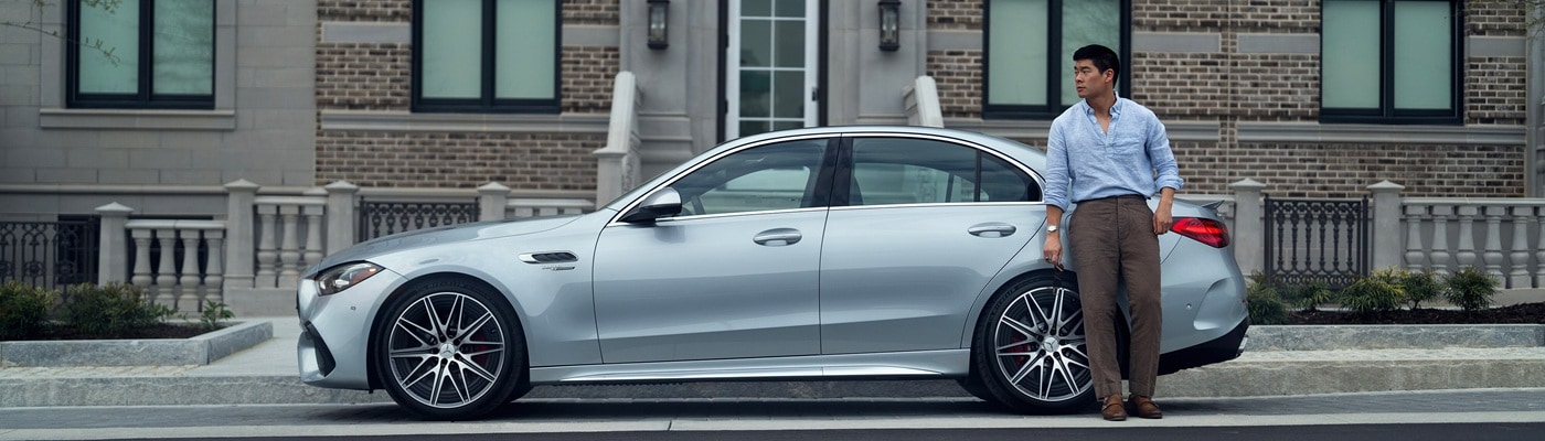 Mercedes-Benz AMG C-Class Silver Mercedes-Benz AMG C 63 parked front of a townhouse