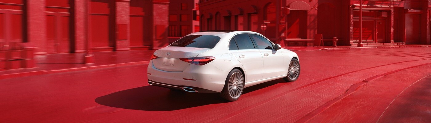 Mercedes-Benz AMG C-Class White Mercedes-Benz AMG C 43 driving thru a red city scape