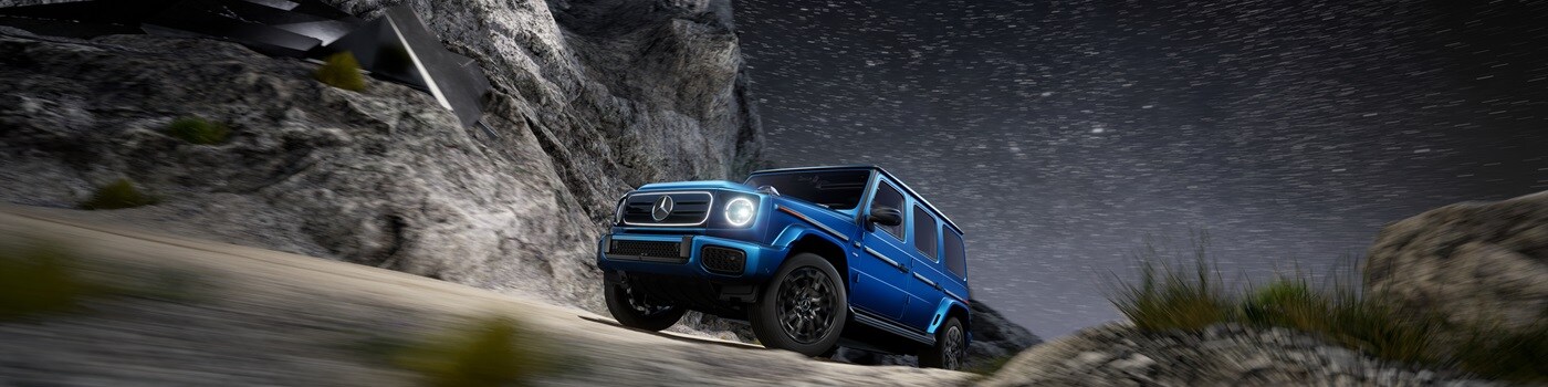Mercedes-Benz G-Class interior Blue Mercedes-Benz G-Class driving in the desert at night