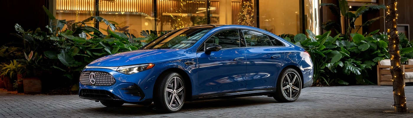 Mercedes-Benz CLA Blue Mercedes-Benz CLA 250+ parked in front of a luxury hotel