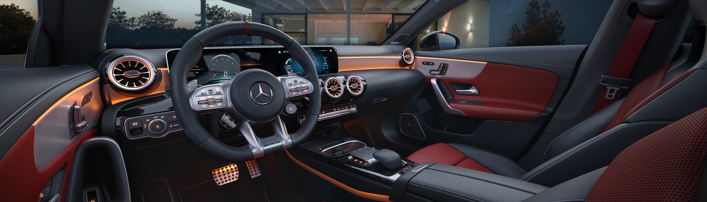 Interior of a Mercedes-Benz AMG CLA parked by a modern home