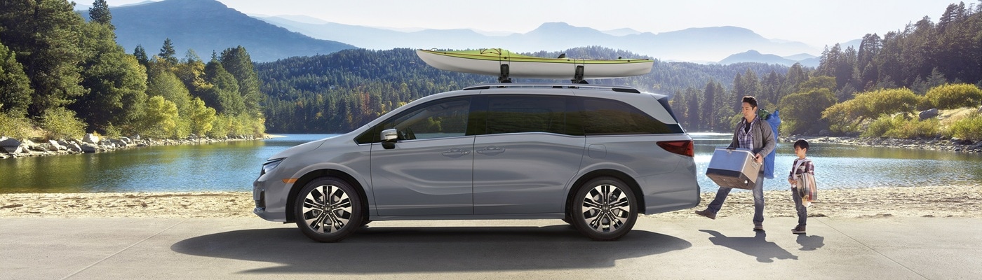 Grey Honda Odyssey Elite parked at a lakeside campground