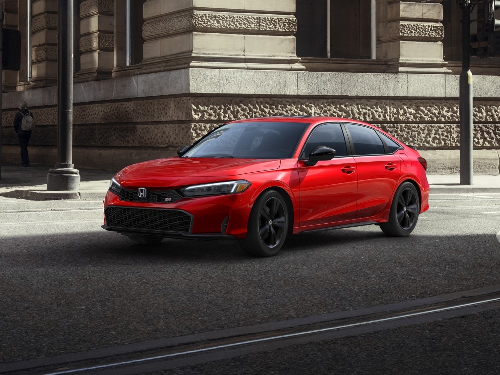 Red Honda Civic Si parked on a city street
