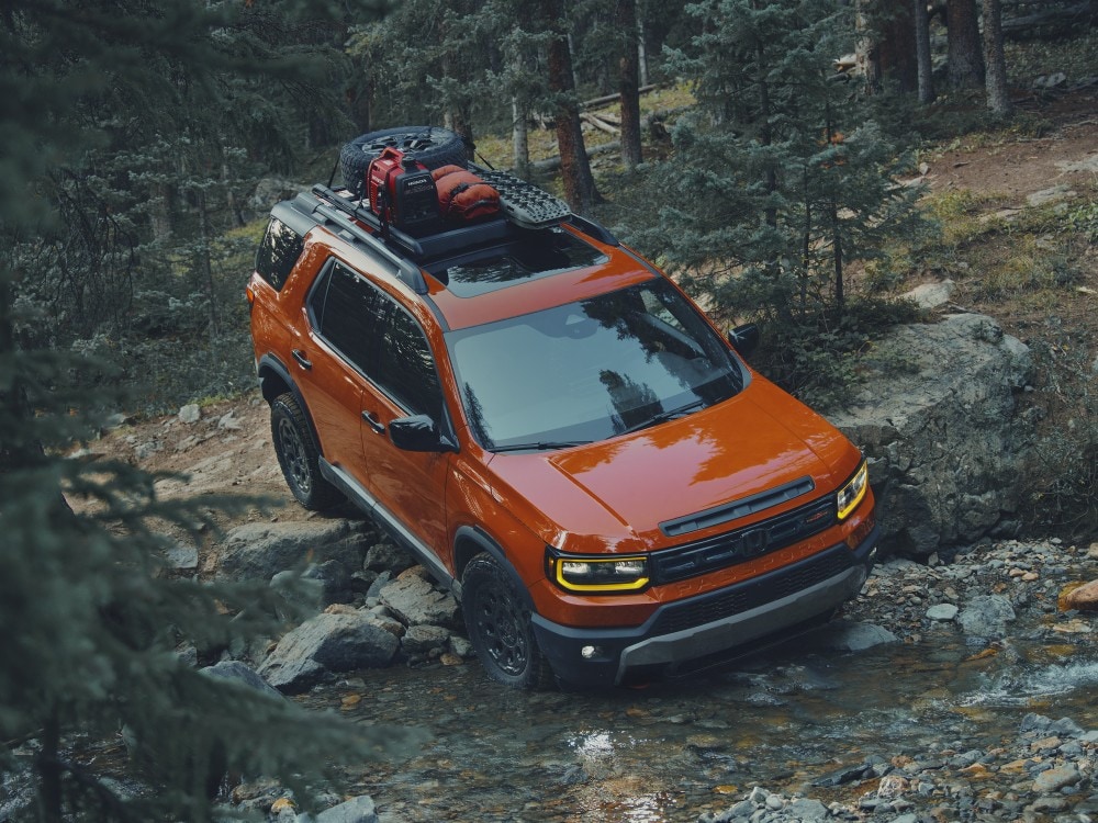People loading bicycles into a silver Honda Passport