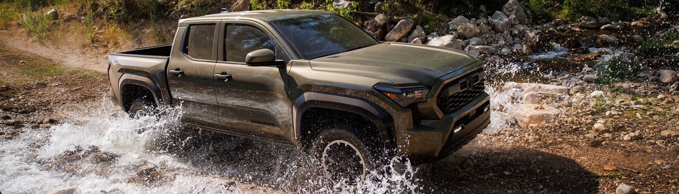 Gold Toyota Tacoma TRD Off-Road fording a river