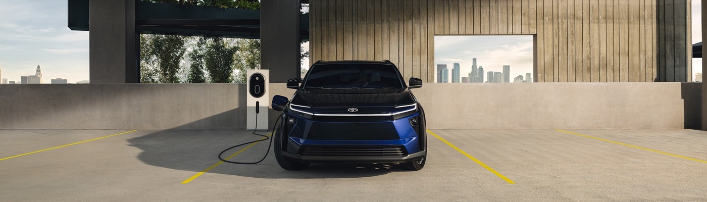 Blue Toyota bZ Limited charging in a parking garage
