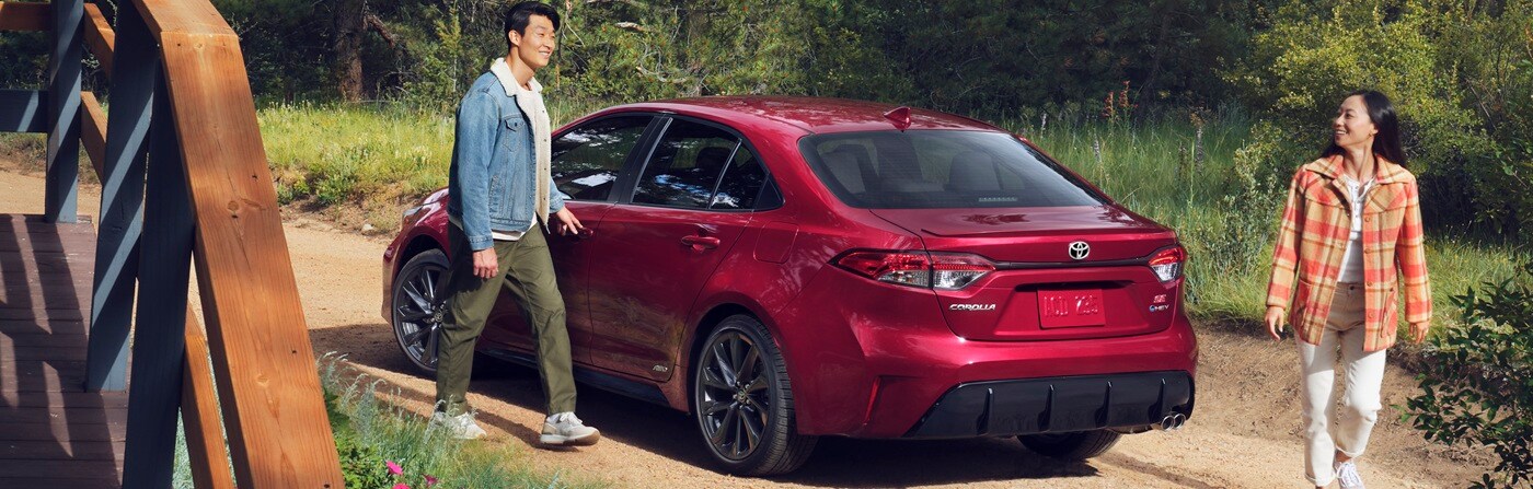 Red Toyota Corolla SE parked by a vacation house