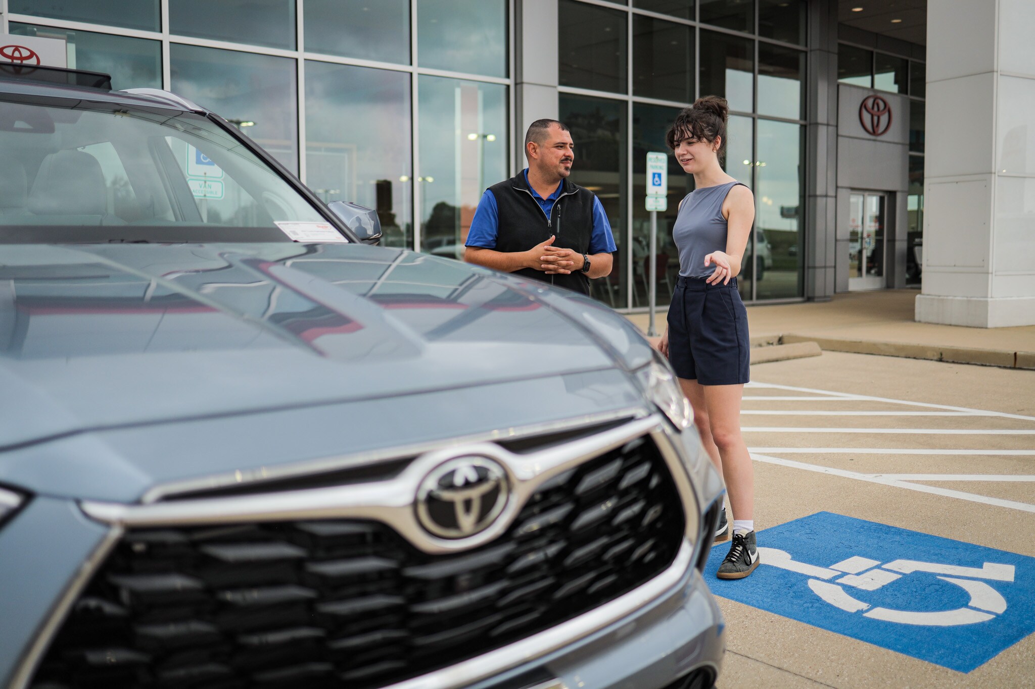 Philpott Toyota Philpott Toyota Storefront with a guest looking at a Highlander