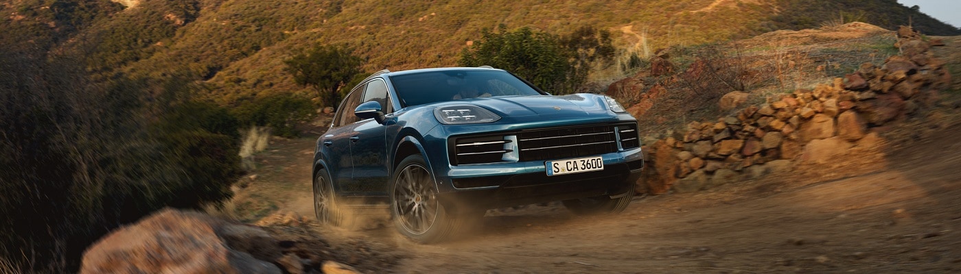 Cayenne driving up a dirt hill