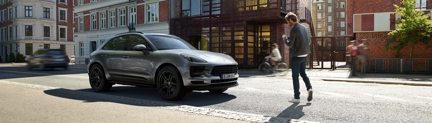 Grey Porsche Macan Base parked on a city street