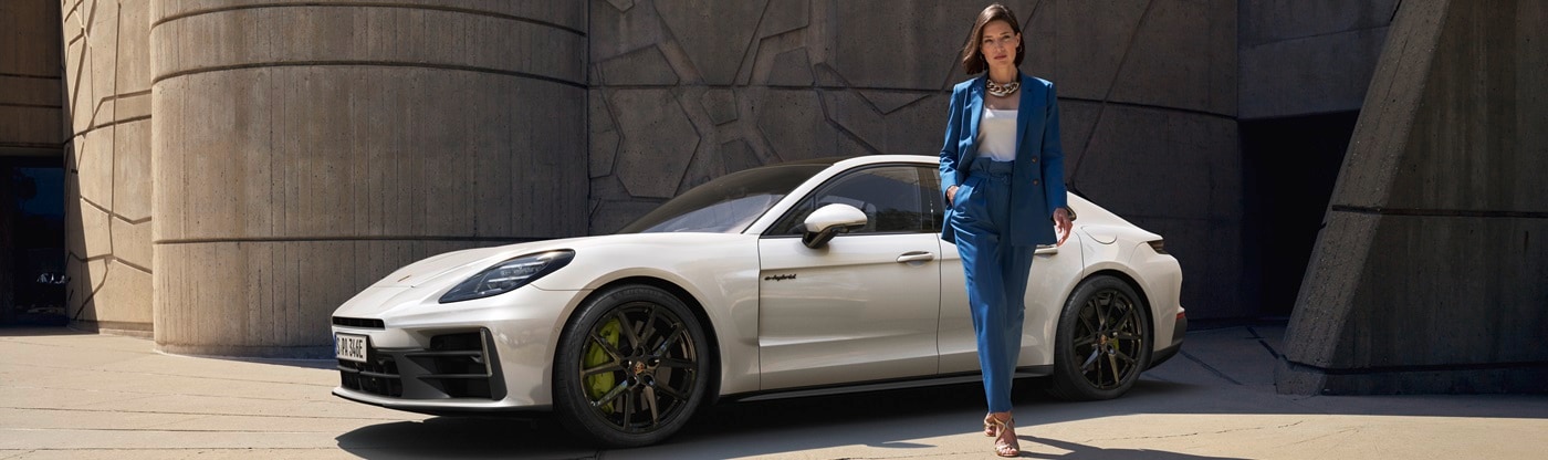 Panamera E-Hybrid with a woman standing in front of the model