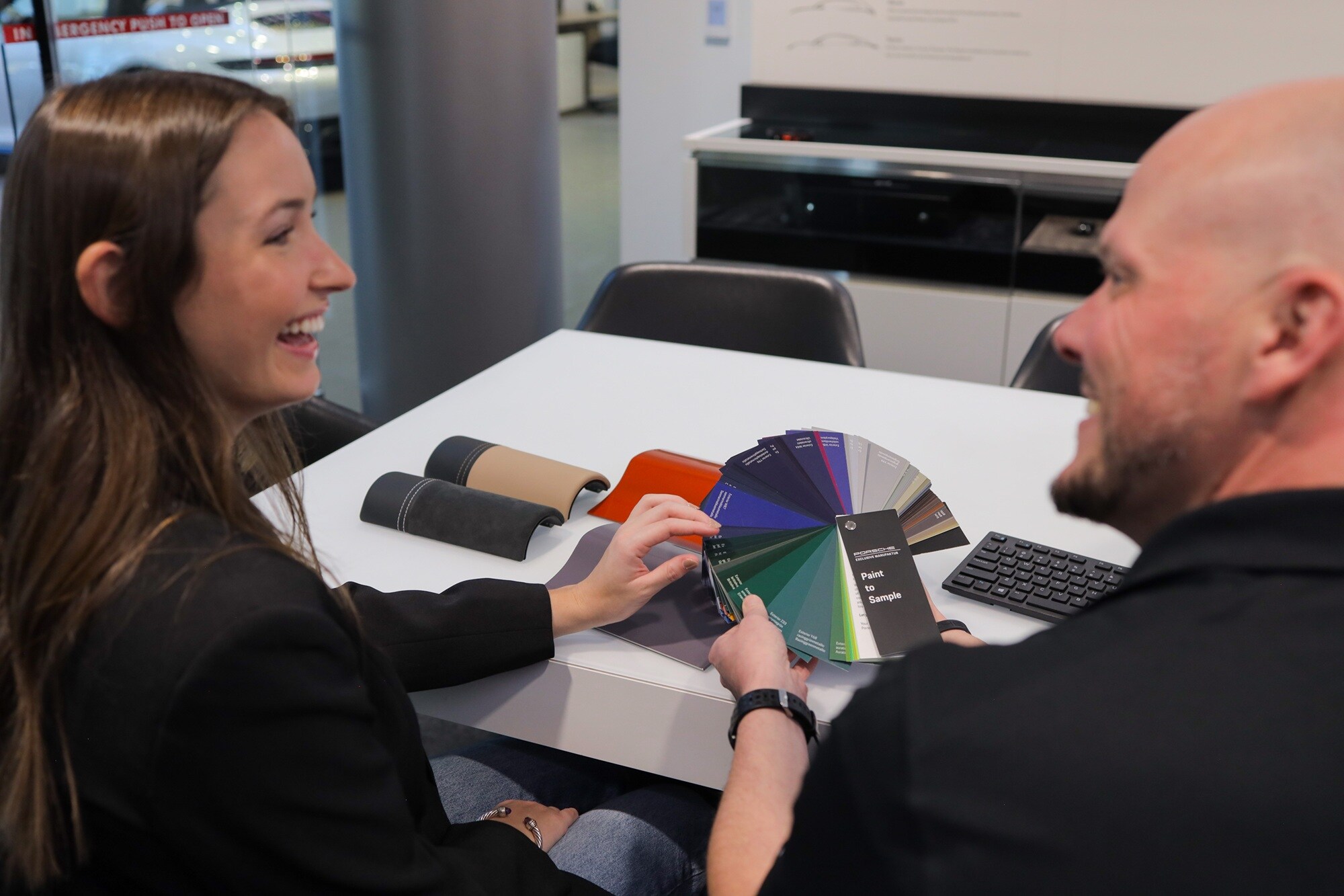 Porsche Bethesda Customization Lounge Porsche Bethesda Customization Lounge with two people looking at color swatches