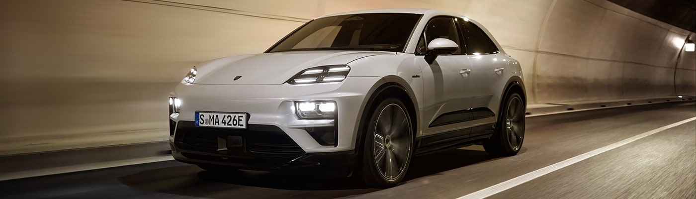 White Macan Turbo Electric driving in a tunnel