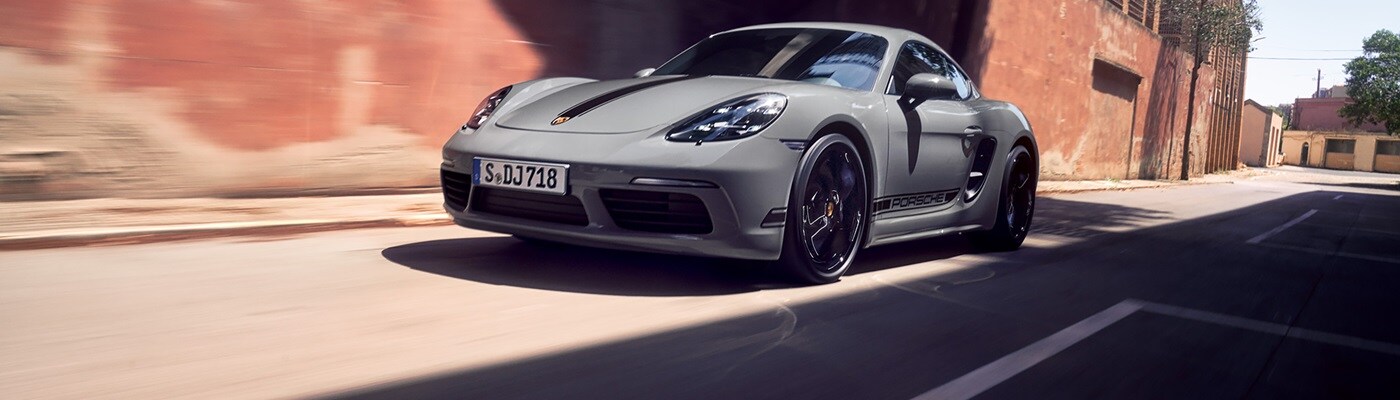 Grey 718 Cayman Style Edition driving thru a desert city