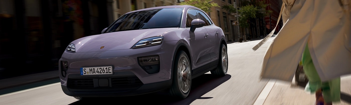 Porsche Macan Electric Lavender Porsche Macan 4 Electric driving in a city