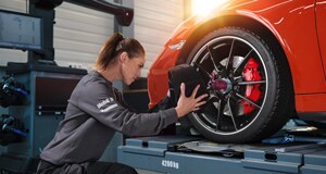 Porsche Alignment Servicing Porsche tech checking a tire for alignment