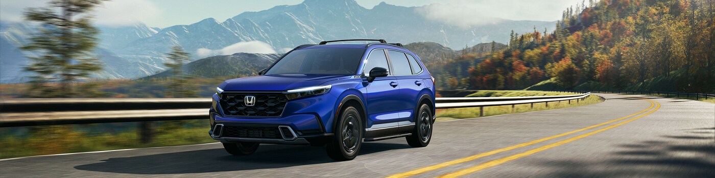 Blue CR-V Hybrid Sport Touring driving on a mountain road