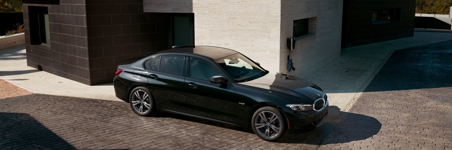 3 Series PHEV parked next to a building